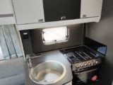 Four-burner hob and sink in kitchen